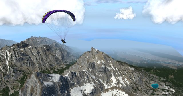 Paraglider above snowy alpine peaks