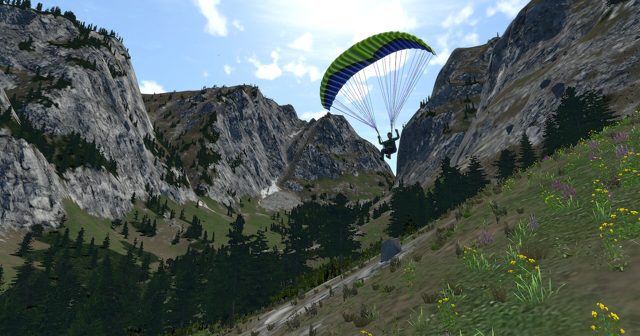 Paraglider flying through a rocky canyon
